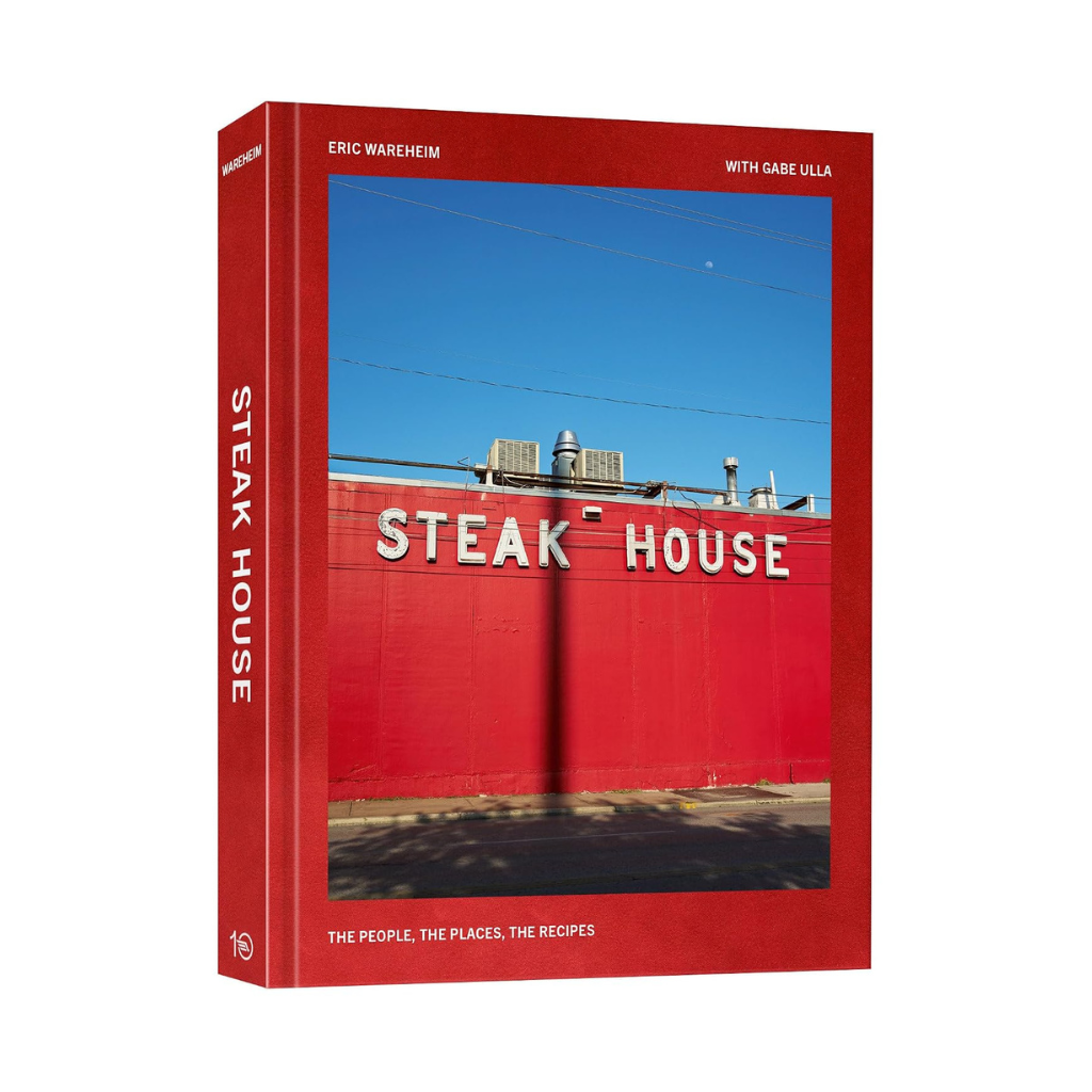 Steak House cookbook by Eric Wareheim, red hardcover with a photo of a red building and a Steak House sign against a blue sky