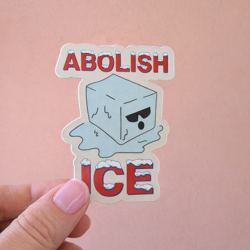 Sticker with 'Abolish Ice' text held by a hand against a pink background