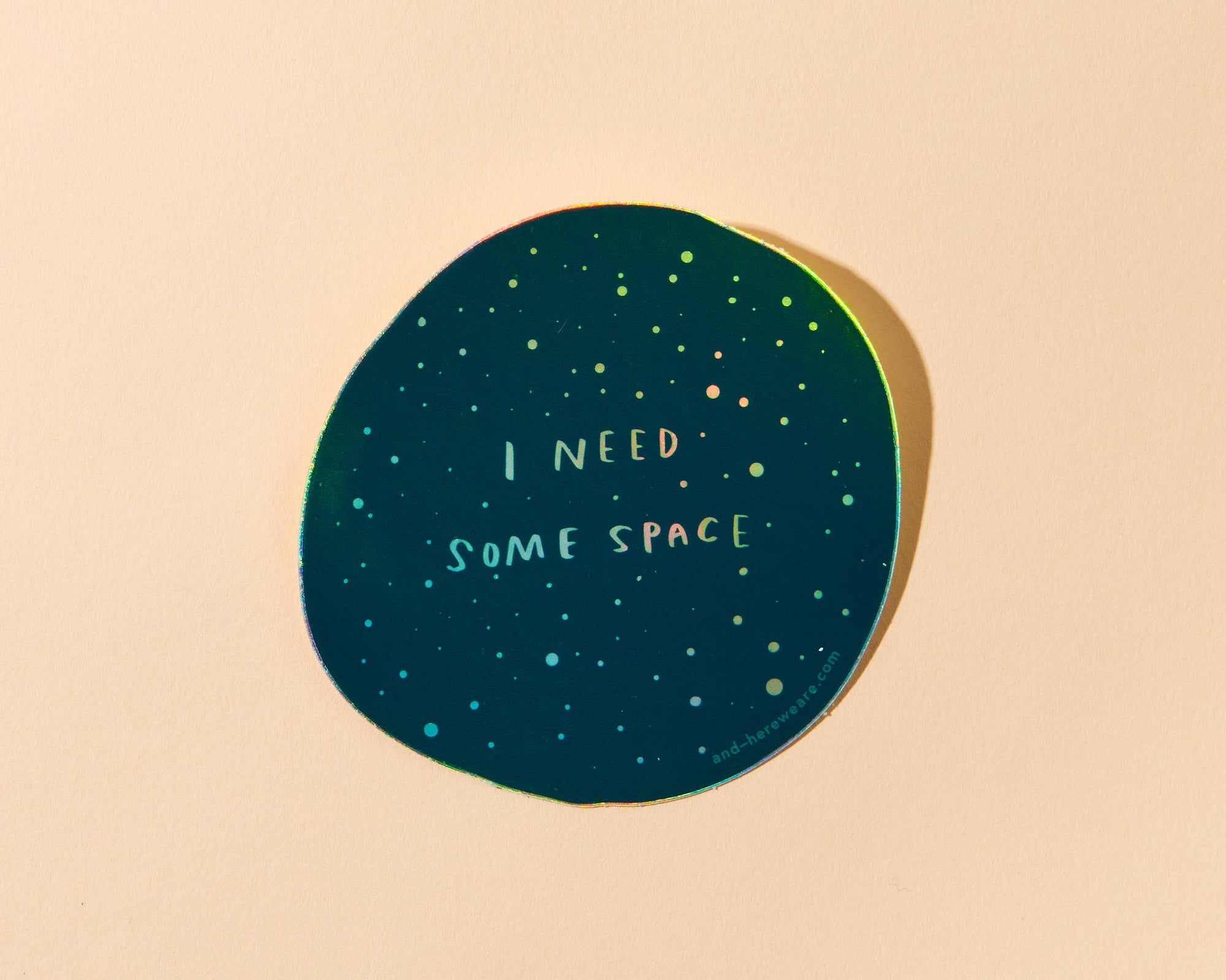 Give me some (literal) space okay? This holographic sticker for the overstimulated reads, "I Need Some Space." Featuring original artwork by Meghan Hopkins Sokorai, this durable, waterproof sticker is dishwasher safe and perfect for laptops, water bottles, notebooks, or anywhere you want to set boundaries with a little sparkle.