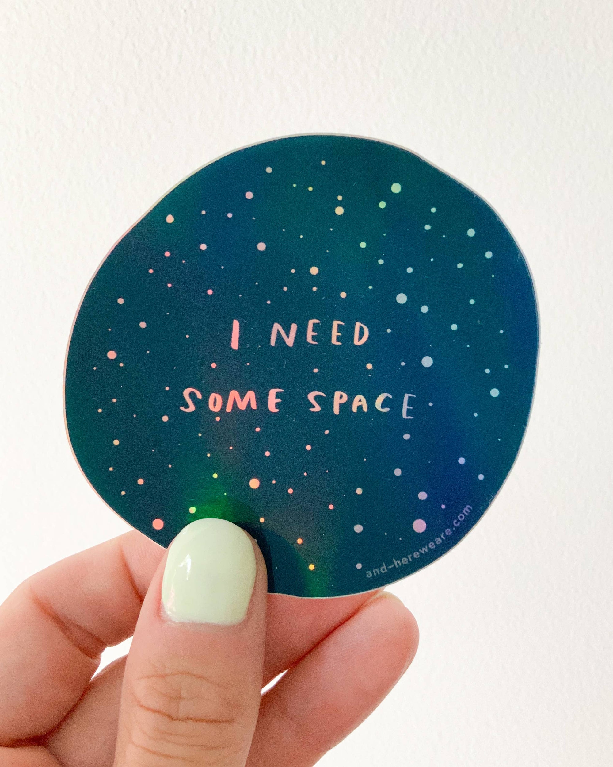 Give me some (literal) space okay? This holographic sticker for the overstimulated reads, "I Need Some Space." Featuring original artwork by Meghan Hopkins Sokorai, this durable, waterproof sticker is dishwasher safe and perfect for laptops, water bottles, notebooks, or anywhere you want to set boundaries with a little sparkle.