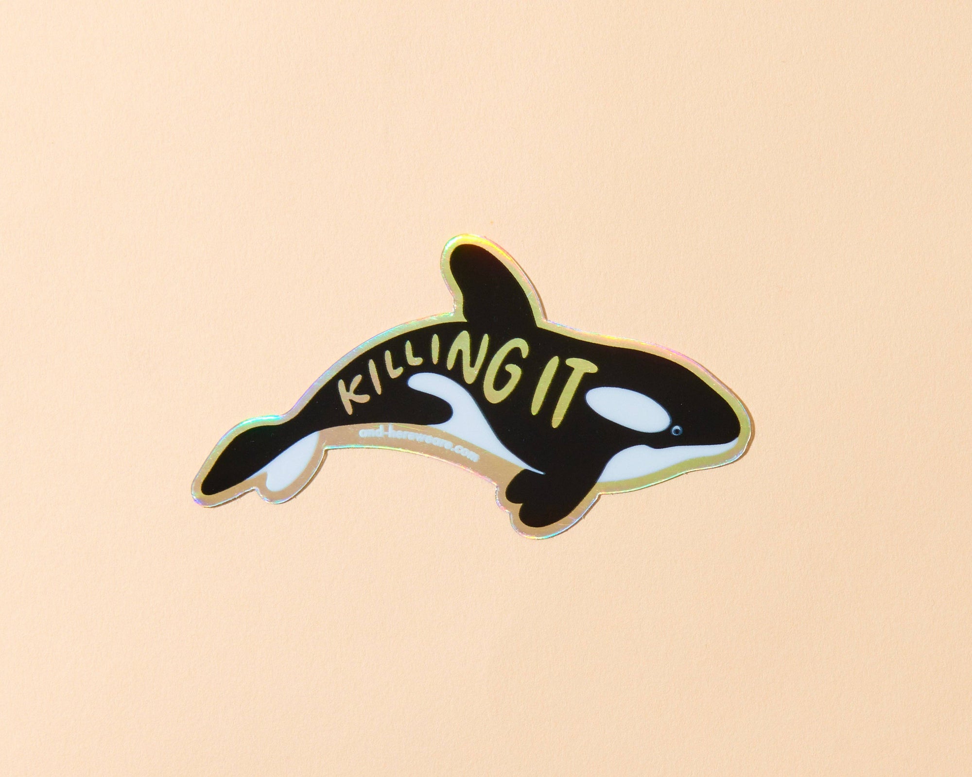 Orca whale sticker with 'KILLING IT' text on a beige background