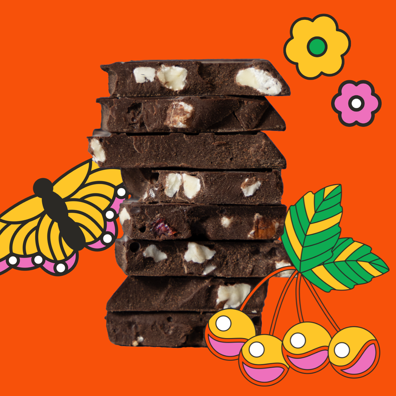 Stack of chocolate bars with white pieces on an orange background with decorative elements.