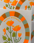 Greeting card with orange flowers and 'Happy Birthday' text on a white background
