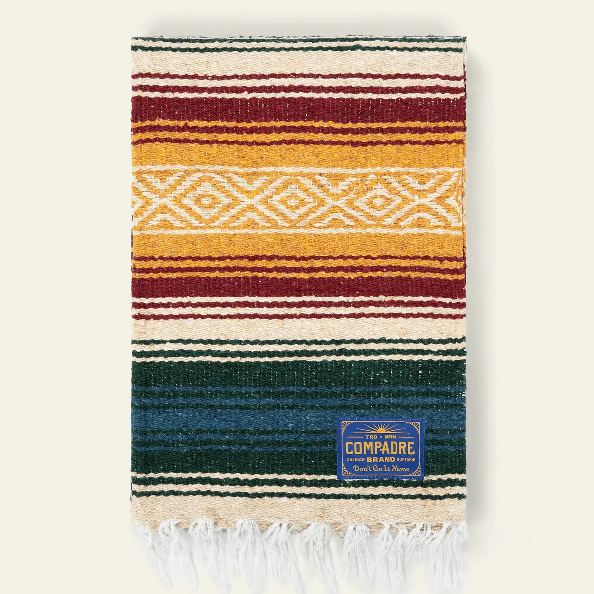Falsa blanket in yellow, maroon, cream and dark green stripes with a cream diamond band