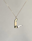 Mini bone-handled pocket knife pendant with the blade open, hanging from a gold-filled chain