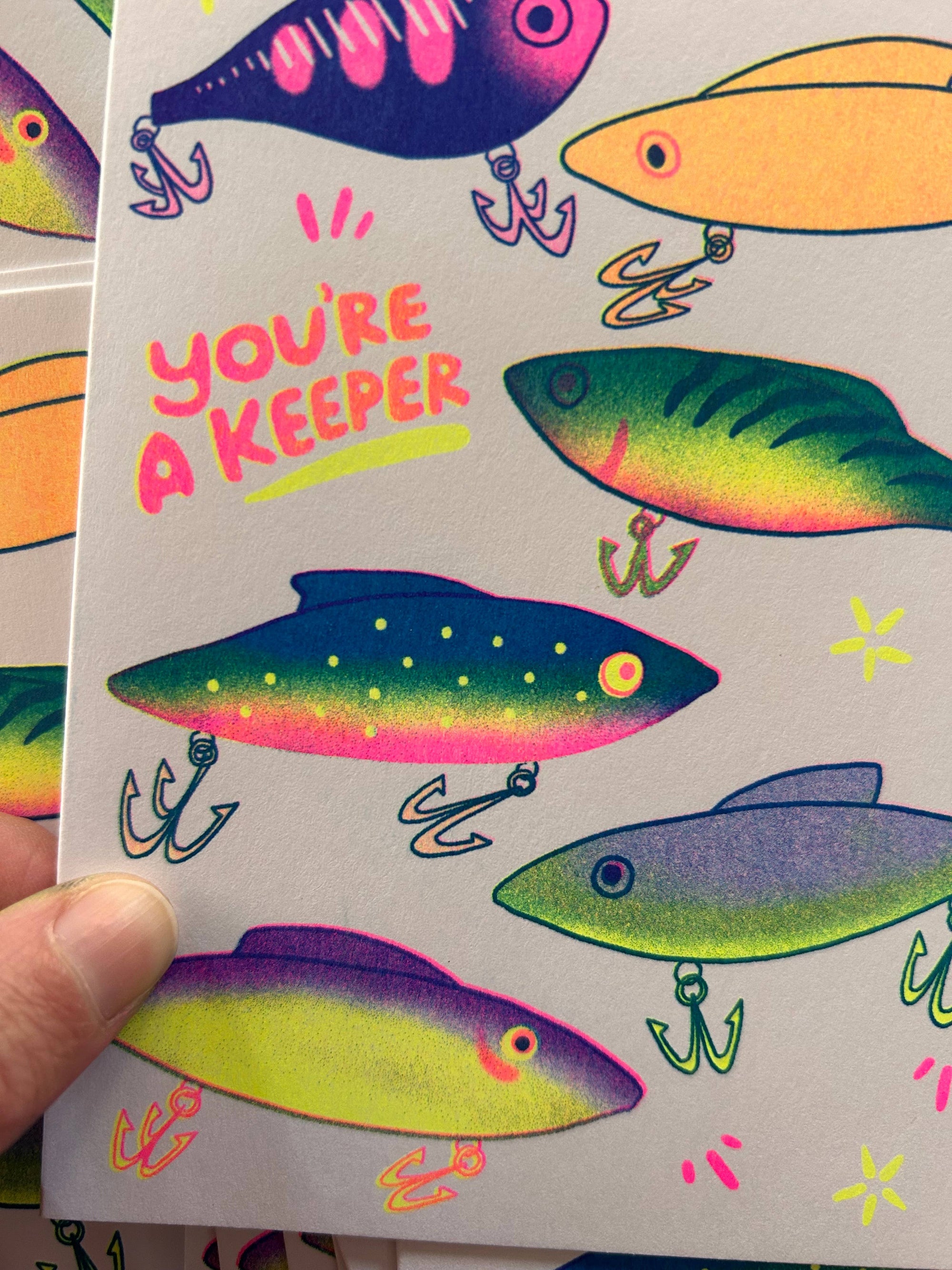 Card with colorful fishing lures and 'You're a Keeper' text
