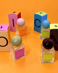 Nellie's Nook Icons perfumes Julia, Dolly, Betsey and Whitney with boxes spelling ICON on an orange background