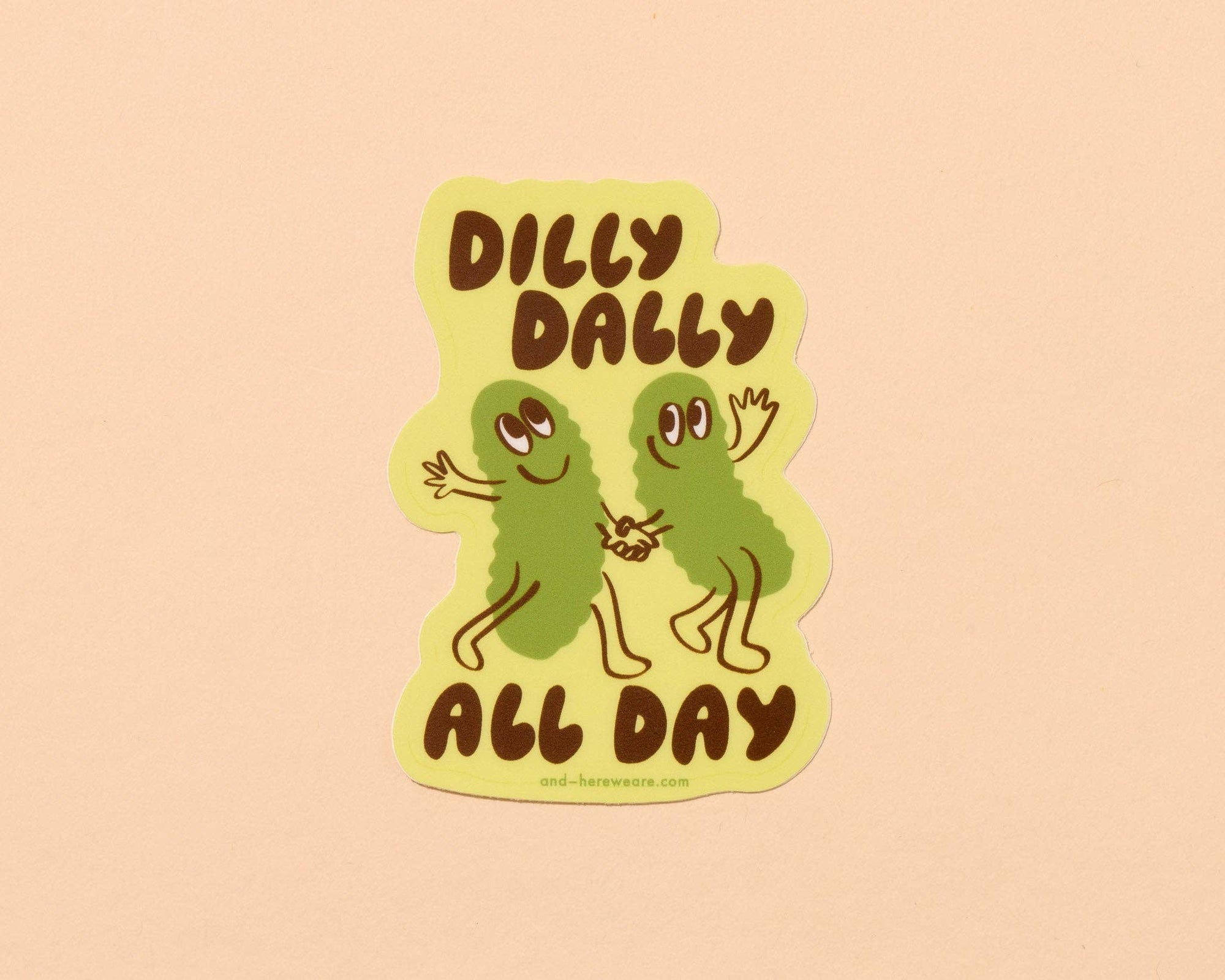 Sticker with two green characters holding hands and text 'Dilly Dally All Day' on a beige background