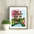 Framed artwork with a nature scene and text on a wooden wall.