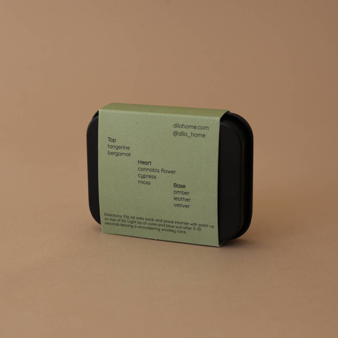 Simply light to fill your space with bright notes of tangerine and cannabis flower that settle into a amber vetiver smoke. Tin contains 25 Incense Cones - Resin + Fragrance Top Notes: tangerine, bergamot Heart Notes: cannabis flower, cypress, moss Base Notes: amber, leather, vetiver