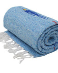 Light blue thunderbird blanket rolled up with white fringe, on a white background