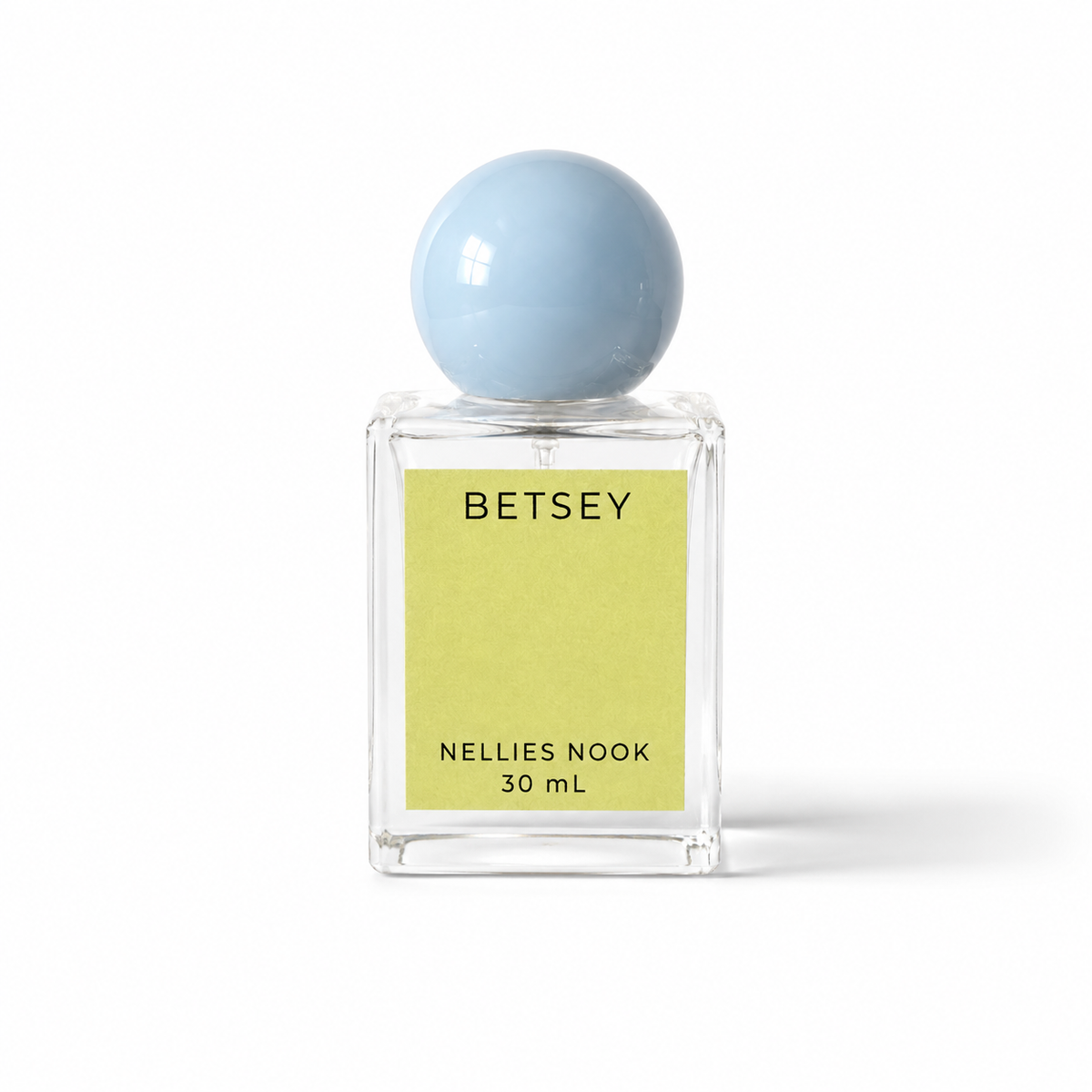 Betsey perfume bottle with a light blue sphere cap and chartreuse label on a white background