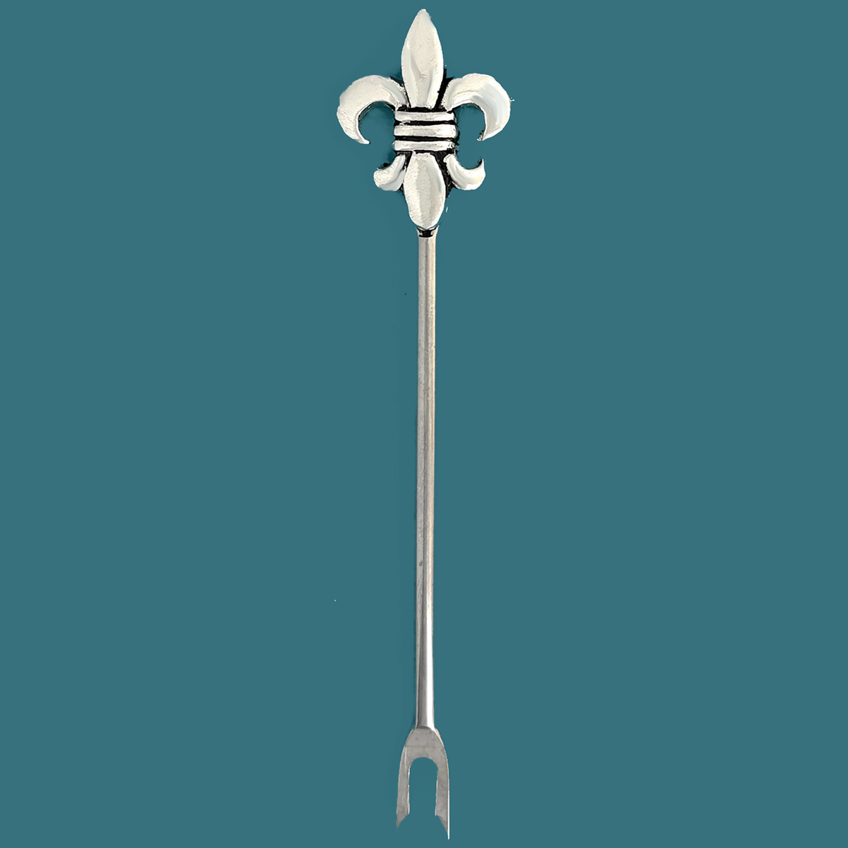 Pewter fleur de lis hors d'oeuvre pick with a two-prong stainless steel stem on a teal background