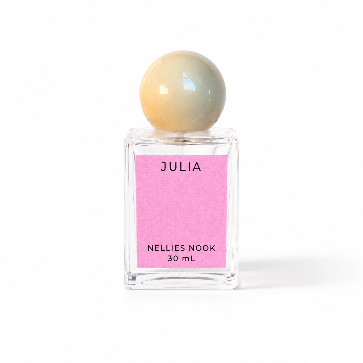 Julia perfume bottle with a cream sphere cap and pink label on a white background