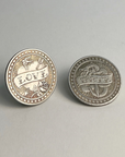 Two silver-toned flip coins, one showing LOVE and one showing HATE, on a light gray background