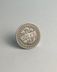 Silver-toned coin showing the HATE side, standing on a light gray background