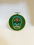 Multicolor sugar skull embroidered on green fabric in a round wood hoop