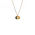Eclipse necklace with overlapping brass and black round pendants on a gold chain, on white