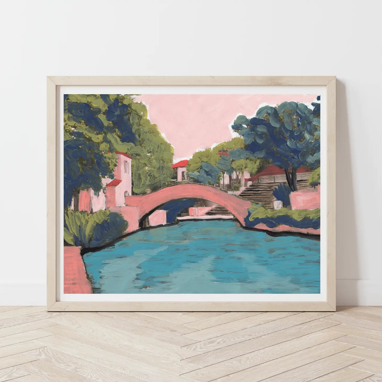 Embark on a visual journey to the heart of San Antonio with this enchanting print, capturing the essence of a leisurely stroll along the iconic River Walk. Offering the best of both worlds, immerse yourself in the charm of shops and restaurants while enjoying the scenic beauty of a riverside promenade. Created by Austin-based artist El Baker, this artwork transforms Texas landscapes into playful masterpieces, ensuring your home is adorned with vibrant colorways that spark joy and bring a touch of San Antoni