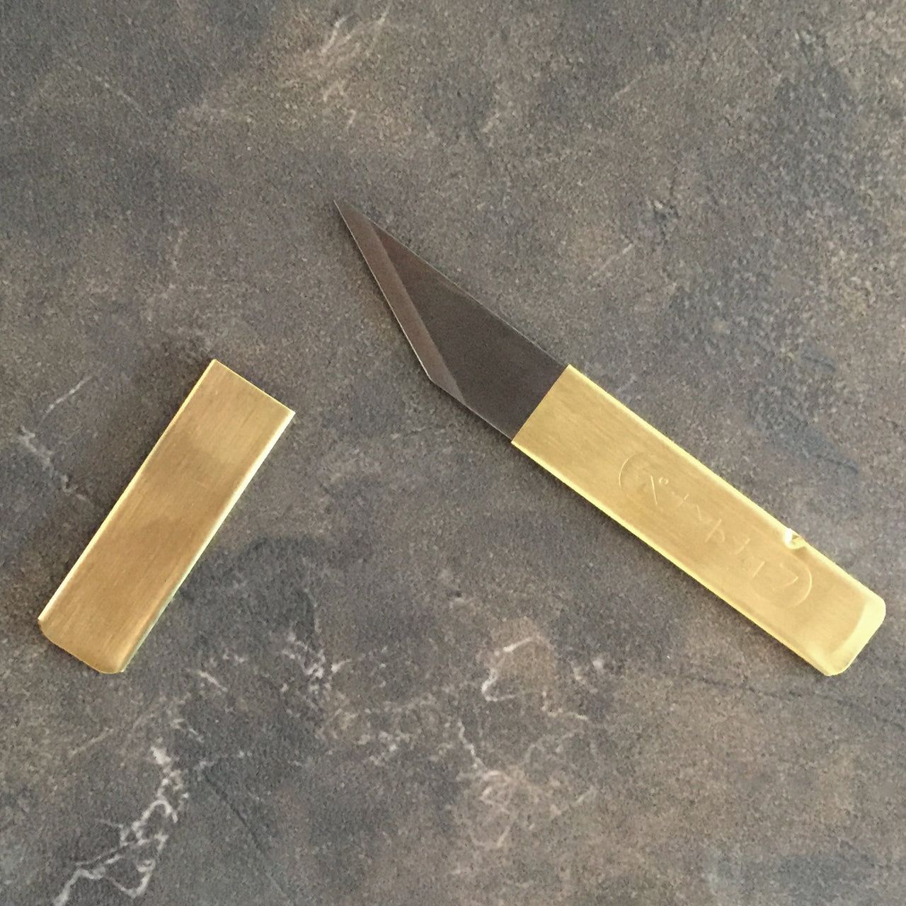 Enhance your everyday carry with the Brass Craft Knife—featuring a mirror-finish stainless steel blade and subtle Japanese characters for a perfect blend of style and function.