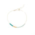 Gold-filled chain anklet with a teal, mustard and blue beaded section on white