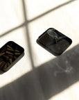 Light a cone to fill your space with smoky peppercorn, palo santo, and amber. 25 incense cones per tin for a warm, grounding aromatic experience.