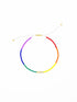 Pride Irena anklet with rainbow glass beads on a white cord, on white